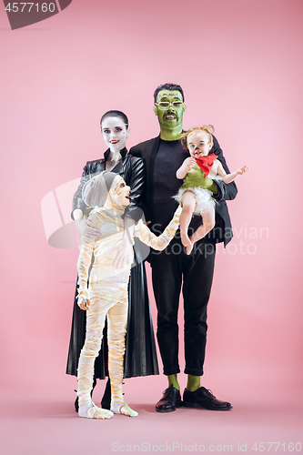 Image of Halloween Family. Happy Father, Mother and Children Girls in Halloween Costume and Makeup