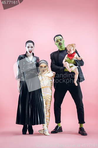 Image of Halloween Family. Happy Father, Mother and Children Girls in Halloween Costume and Makeup