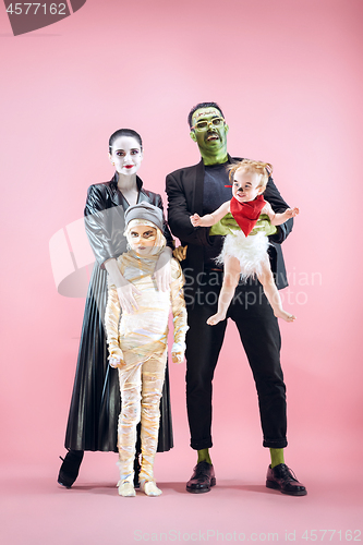 Image of Halloween Family. Happy Father, Mother and Children Girls in Halloween Costume and Makeup