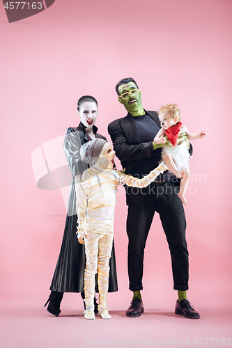 Image of Halloween Family. Happy Father, Mother and Children Girls in Halloween Costume and Makeup