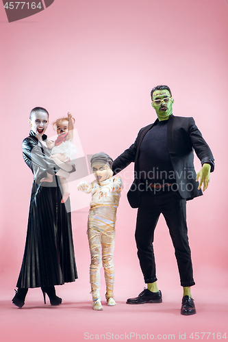 Image of Halloween Family. Happy Father, Mother and Children Girls in Halloween Costume and Makeup