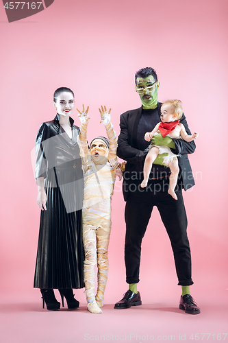 Image of Halloween Family. Happy Father, Mother and Children Girls in Halloween Costume and Makeup