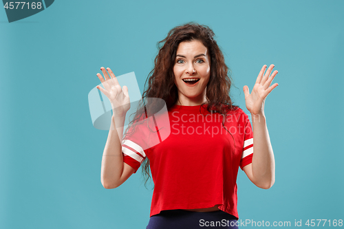 Image of Beautiful woman looking suprised isolated on blue