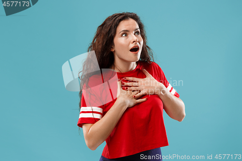 Image of Beautiful woman looking suprised isolated on blue