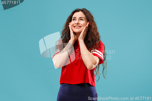 Image of The happy business woman standing and smiling against blue background.