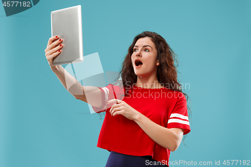 Image of The happy businesswoman with red laptop on blue