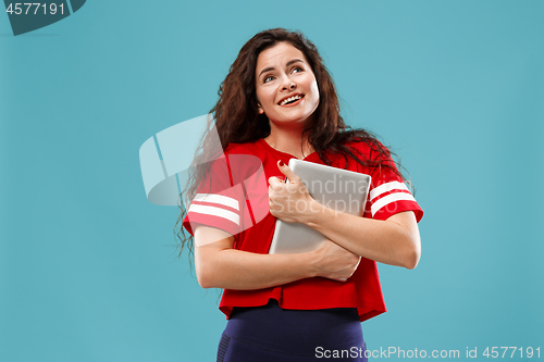 Image of The happy businesswoman with red laptop on blue