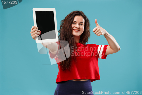 Image of The happy businesswoman with red laptop on blue
