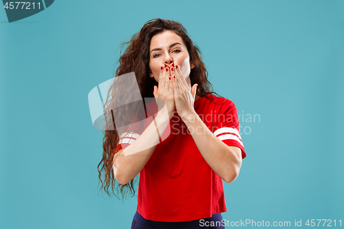 Image of The happy business woman standing and smiling against blue background.