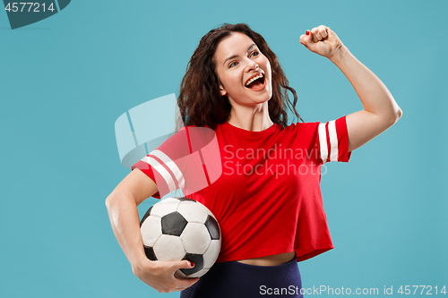 Image of Fan sport woman player holding soccer ball isolated on blue background