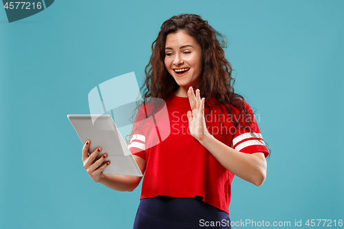 Image of The happy businesswoman with red laptop on blue