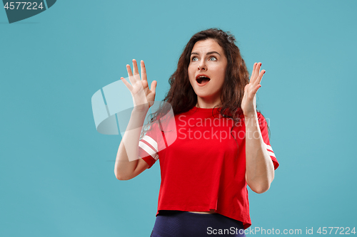 Image of Beautiful woman looking suprised isolated on blue