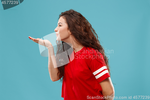 Image of The happy business woman standing and smiling against blue background.