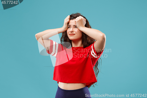 Image of Beautiful woman in stress isolated on blue