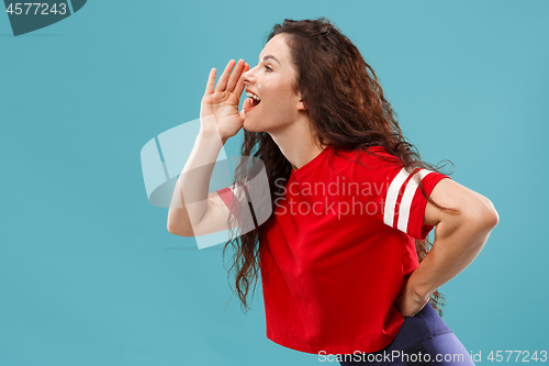 Image of Isolated on pink young casual woman shouting at studio