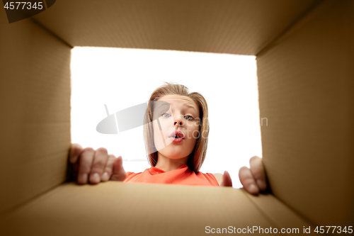 Image of happy surprised girl looking into gift box