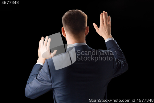 Image of businessman working with invisible virtual screen