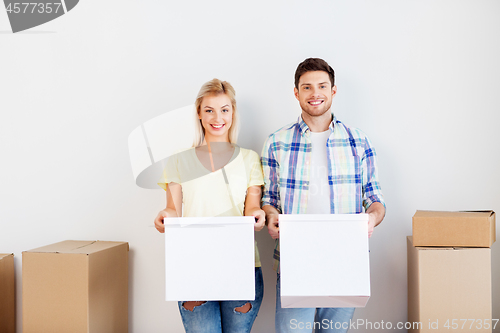 Image of happy couple with boxes moving to new home