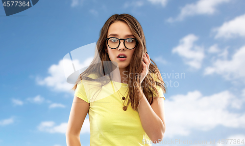 Image of scared young woman or teenage girl in glasses