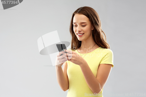 Image of young woman or teenage girl using smartphone