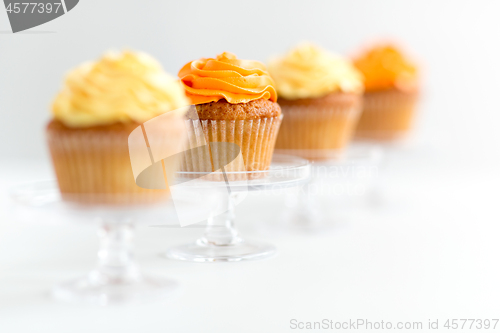 Image of cupcakes with frosting on confectionery stands