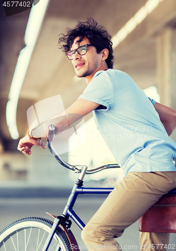 Image of young hipster man riding fixed gear bike