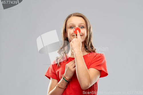 Image of smiling teenage girl with red clown nose