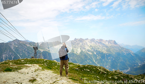 Image of tourist taking a landscape of French Alps