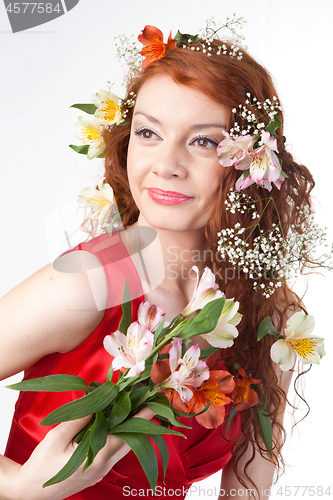 Image of Portrait of beautiful woman with spring flowers