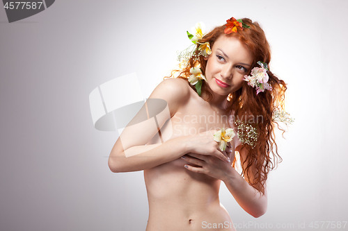 Image of Portrait of beautiful naked woman with spring flowers 