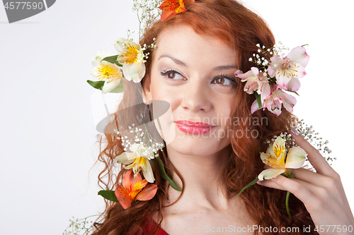 Image of Portrait of beautiful woman with spring flowers on white