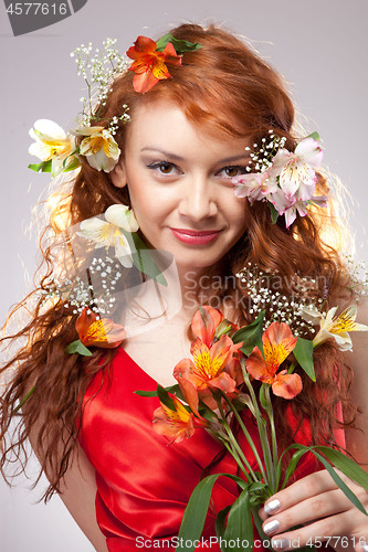 Image of Portrait of beautiful woman with spring flowers 