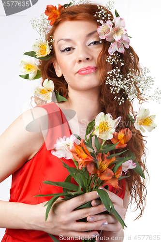 Image of Portrait of beautiful woman with spring flowers