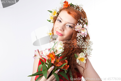 Image of Portrait of beautiful woman with spring flowers