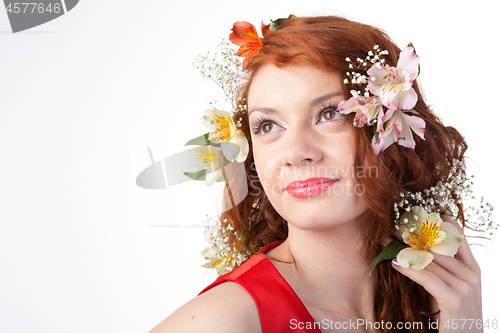 Image of Portrait of beautiful woman with spring flowers on white