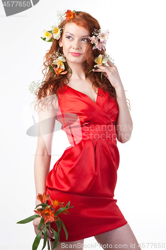 Image of Portrait of woman in red dress with spring flowers on white