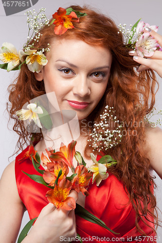 Image of Portrait of beautiful woman with spring flowers 