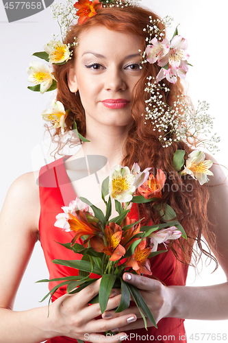 Image of Portrait of beautiful woman with spring flowers