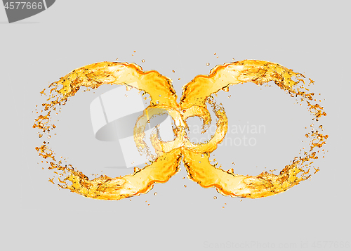 Image of Splashing beer waves in the form of infinity symbol.