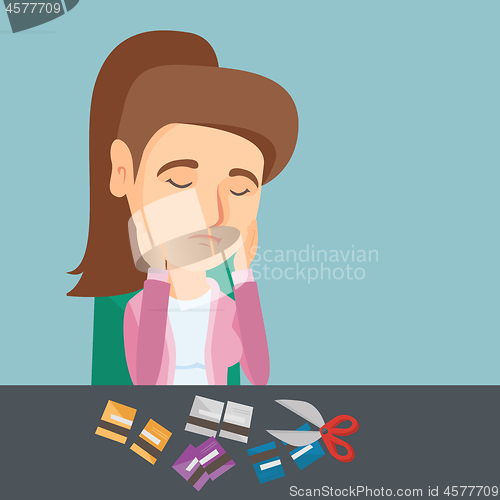 Image of Young caucasian woman cutting credit cards.