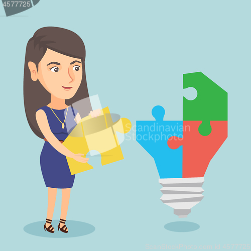 Image of Businesswoman completing lightbulb made of puzzle.