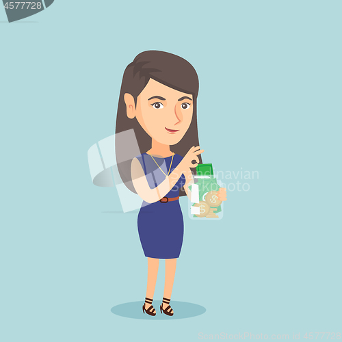 Image of Caucasian woman putting dollar into a glass jar.