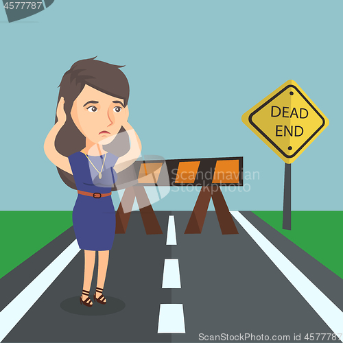 Image of Businesswoman looking at road sign dead end.