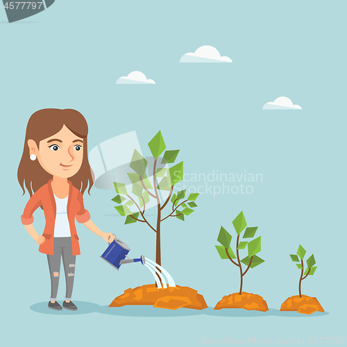 Image of Young caucasian business woman watering trees.