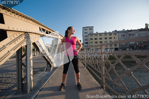 Image of portrait of a jogging woman at sunny morning