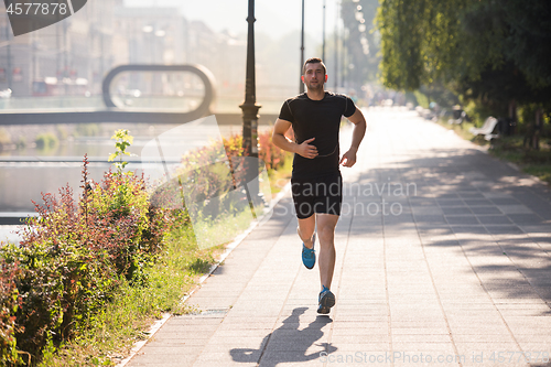 Image of man jogging at sunny morning