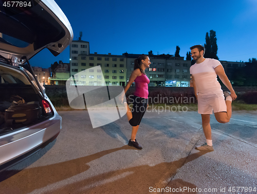 Image of couple warming up and stretching