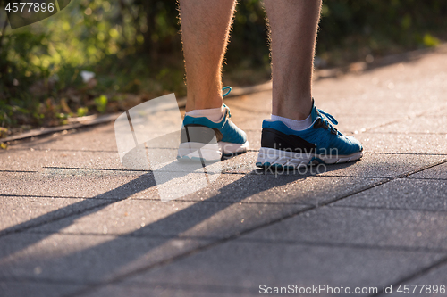 Image of woman jogging at sunny morning