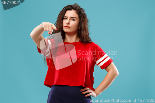 Image of The overbearing business woman point you and want you, half length closeup portrait on blue background.
