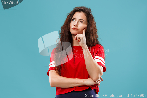 Image of Young serious thoughtful business woman. Doubt concept.